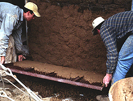 An adobe cage being lifted into place, Arroyo Seco, NM, 2001.