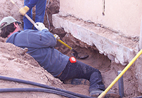 Excavating for a basket in Jacona, NM, 2002.